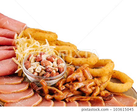 Dried beef, fried pig ears, onion rings, calamari, nuts, on a plate Dried beef, fried pig ears, onion rings, calamari, nuts, on a plate 103615045