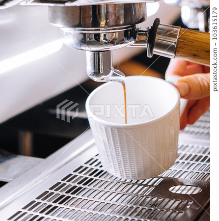 Professional coffee machine with white cup and pouring drink Professional coffee machine with white cup and pouring drink 103615179