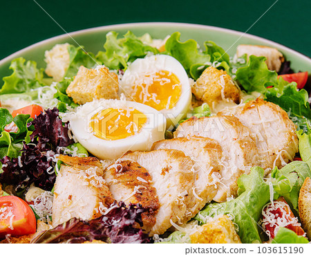 Caesar salad with chicken breast on green background 103615190
