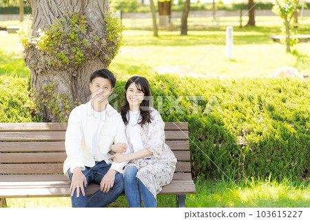 Photo of a couple sitting on a bench 103615227