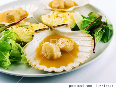 Seared scallops shell with butter on plate 103615543