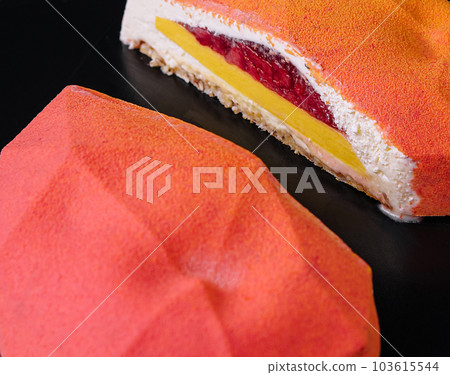 Strawberry mango mousse cake on plate 103615544