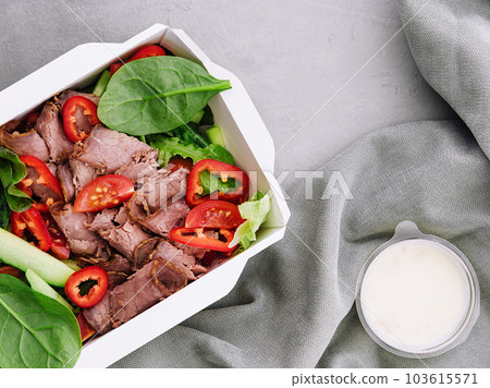 Beef steak salad with cherry tomatoes, cucumbers and basil 103615571