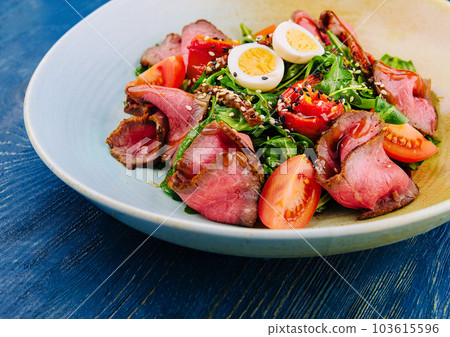 Veal carpaccio with arugula and eggs Veal carpaccio with arugula and eggs 103615596