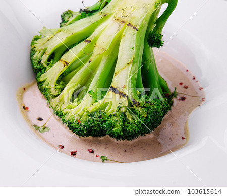 Broccoli steak with walnut sauce on plate 103615614