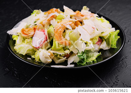 Delicious fresh caesar salad on black plate 103615621