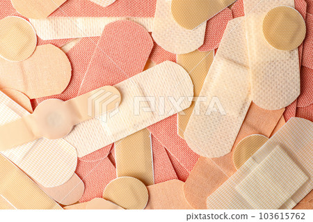 Different medical sticking plasters as background, closeup. First aid item 103615762