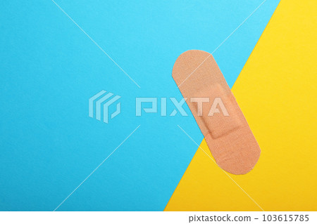 Sticking plaster on color background, top view. Space for text 103615785