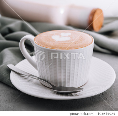 Close up of Cup of coffee with heart flower painted on foam 103615925