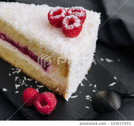 Winter cake with white cream decorated raspberries 103615935