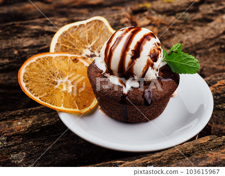 Chocolate fondant cake, molten lava cake with lemon slices Chocolate fondant cake, molten lava cake with lemon slices 103615967