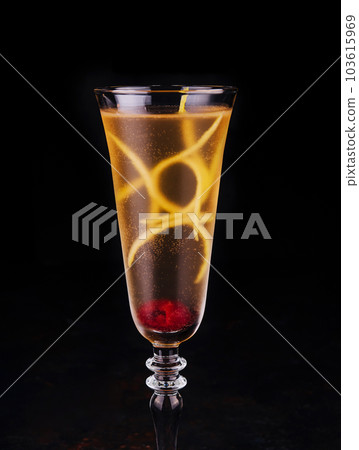 Elegant glass of yellow champagne with raspberry 103615969