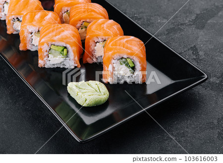 Delicious philadelphia sushi on black stone plate 103616003