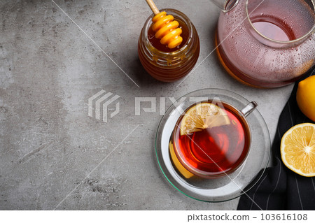 Flat lay composition of tea with honey on light grey table. Space for text 103616108
