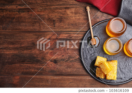 Flat lay composition with delicious honey on wooden table. Space for text 103616109
