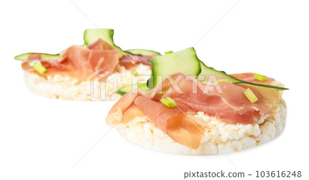 Puffed rice cakes with prosciutto and cucumber isolated on white 103616248