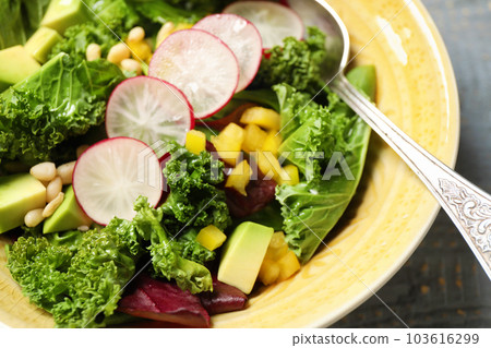Delicious fresh kale salad in bowl, closeup 103616299