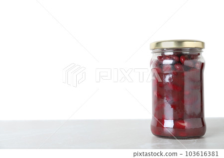 Glass jar of pickled red beans on light marble table. Space for text Glass jar of pickled red beans on light marble table. Space for text 103616381