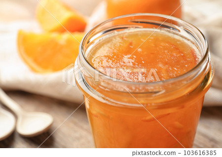 Homemade delicious orange jam on table, closeup view 103616385