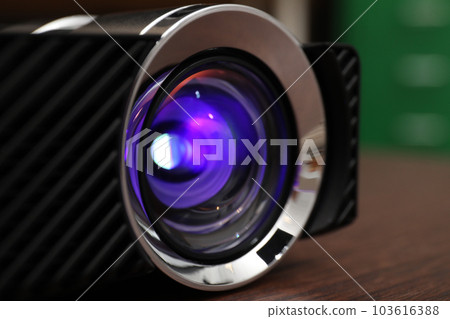 Closeup view of modern digital video projector on table Closeup view of modern digital video projector on table 103616388