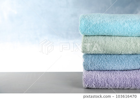 Stack of clean bath towels on grey table. Space for text Stack of clean bath towels on grey table. Space for text 103616470