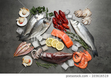 Fresh fish and seafood on grey table, flat lay Fresh fish and seafood on grey table, flat lay 103616519