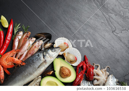 Fresh fish and different seafood on black table, flat lay. Space for text 103616538