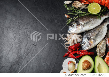 Fresh fish and different seafood on black table, flat lay. Space for text 103616539