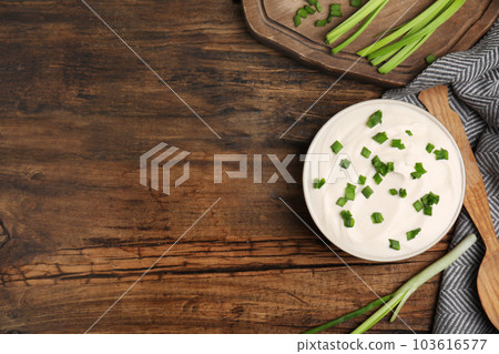 Fresh sour cream with onion on wooden table, flat lay. Space for text Fresh sour cream with onion on wooden table, flat lay. Space for text 103616577