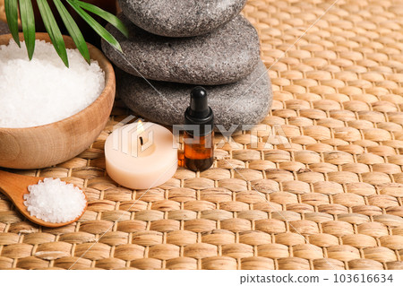 Beautiful spa composition with essential oil on wicker mat 103616634