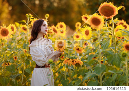 Beautiful woman in a dress in a field of sunflowers 103616813
