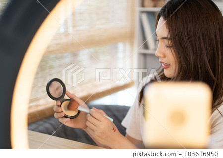 Beautiful women with social media influences are teaching makeup and use cosmetics, In front of the camera to recording vlog video live streaming, Online business on concept of beauty bloggers. 103616950