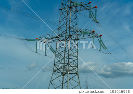 High voltage towers with sky background. Power line support with wires for electricity transmission. High voltage grid tower with wire cable at distribution station. Energy industry, energy saving 103616958