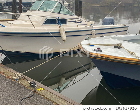 Boats tied up at a dock on a foggy morning 103617920