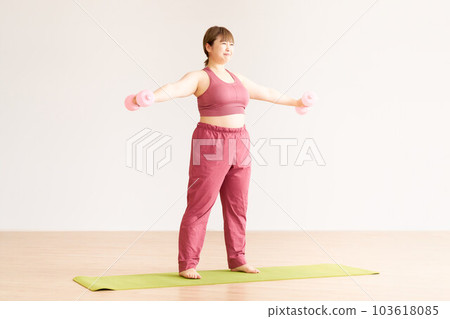 Plump young woman doing training plus size model image 103618085