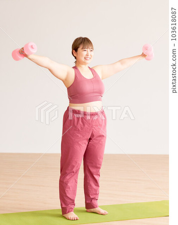 Plump young woman doing training plus size model image 103618087