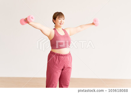 Plump young woman doing training plus size model image 103618088