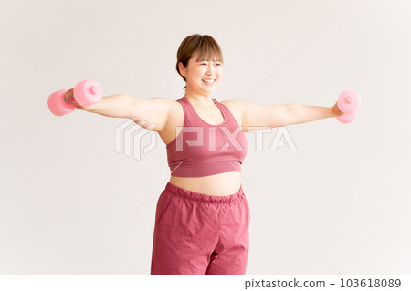 Plump young woman doing training plus size model image 103618089
