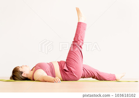 Chubby young woman doing yoga plus size model image 103618102