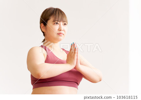 Chubby young woman doing yoga plus size model image 103618115
