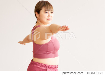 Chubby young woman doing yoga plus size model image 103618139