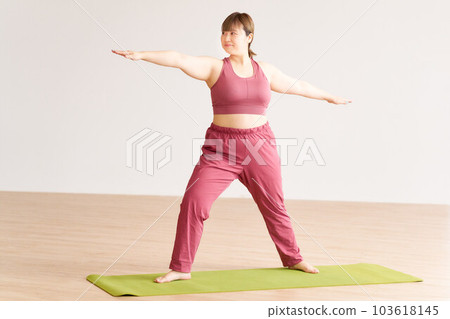 Chubby young woman doing yoga plus size model image 103618145