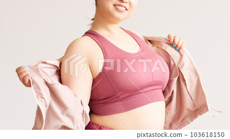 Image of a plump woman's upper body plus size model wearing yoga wear 103618150