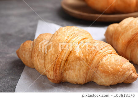 Tasty fresh croissants on grey table, closeup 103618176