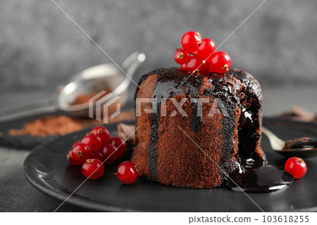 Delicious warm chocolate lava cake with berries on plate, closeup 103618255