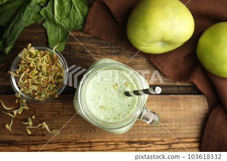 Flat lay composition with green buckwheat smoothie on wooden table 103618332