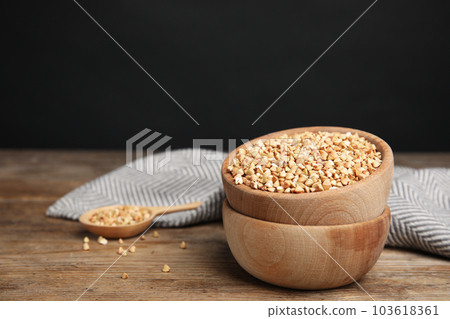 Green buckwheat on wooden table, space for text 103618361