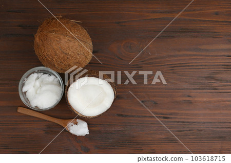 Flat lay composition with organic coconut oil on wooden table, space for text. Healthy cooking Flat lay composition with organic coconut oil on wooden table, space for text. Healthy cooking 103618715