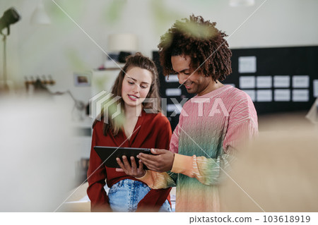 Portrait of young colleagues in their creative studio. Portrait of young colleagues in their creative studio. 103618919