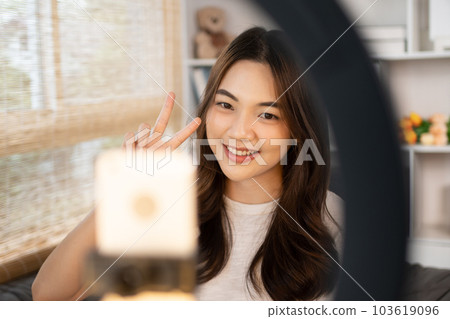 Beautiful woman with a social media influence is greeting the audience for recording vlog video live streaming, Showing how to make up and use cosmetics, Online business on concept of beauty bloggers. 103619096